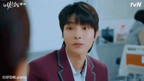 A Young Man In A Purple Suit And White Shirt Is Looking At A Woman . GIF