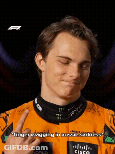 A Young Man In A Racing Suit Is Giving The Middle Finger GIF