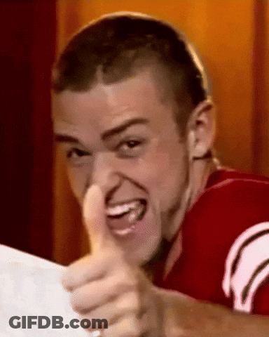 A Young Man In A Red Shirt Is Giving A Thumbs Up Sign . GIF