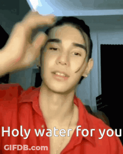 A Young Man In A Red Shirt Is Saying Holy Water For You . GIF