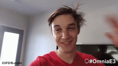 A Young Man In A Red Shirt With The Hashtag #Omniae3 On The Bottom GIF