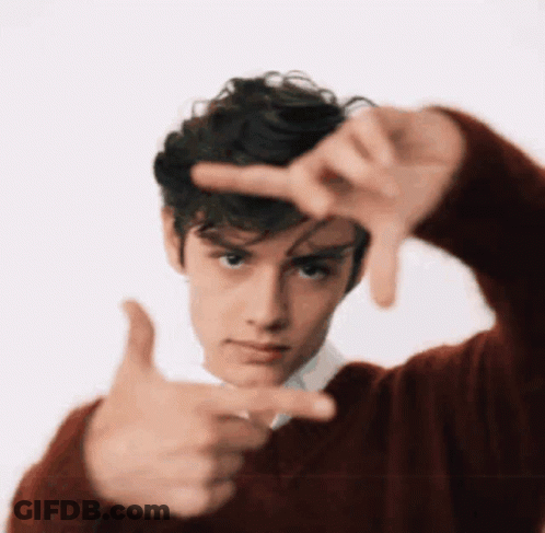 A Young Man In A Red Sweater Making A Frame With His Hands GIF