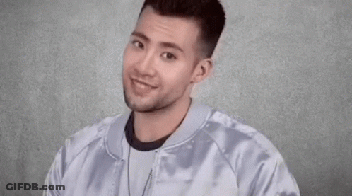 Young Man Smiling And Making Funny Face GIF