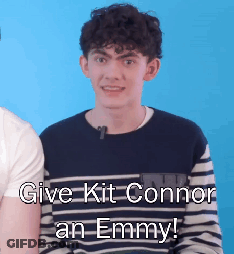 A Young Man In A Striped Shirt Says " Give Kit Connor An Emmy ! " GIF
