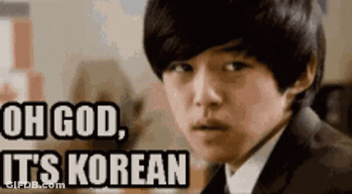 A Young Man In A Suit And Tie Is Looking At The Camera With The Words Oh God It 'S Korean Above Him . GIF
