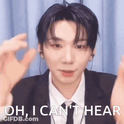 A Young Man In A Suit And Tie Is Saying Oh , I Can 'T Hear GIF