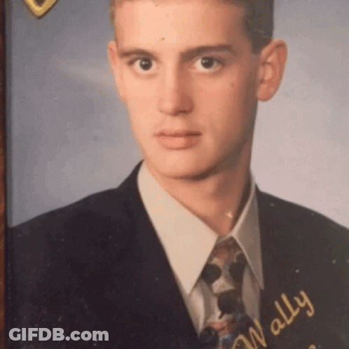 A Young Man In A Suit And Tie With The Name Wally GIF