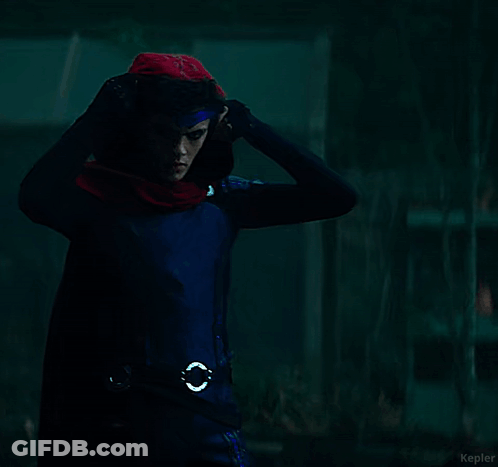 A Young Man In A Superhero Costume With A Scarf Around His Neck GIF