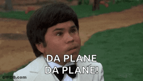 A Young Man In A Tuxedo And Bow Tie Is Saying Da Plane Da Plane ! GIF