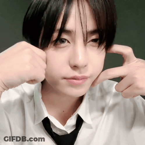 A Young Man In A White Shirt And Black Tie Is Making A Face GIF