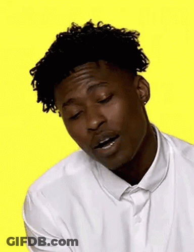 A Young Man In A White Shirt And Tie Is Smiling . GIF