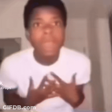 A Young Man In A White Shirt Is Making A Funny Face With His Hands On His Chest . GIF