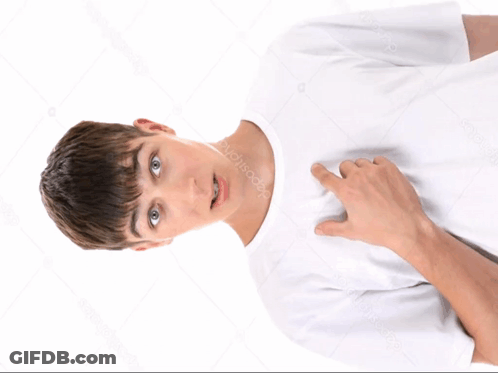 A Young Man In A White T-Shirt Is Pointing To His Chest GIF