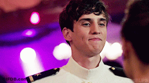 A Young Man In A White Uniform Looks At A Woman GIF