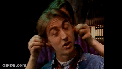 A Young Man Is Covering His Ears With His Hands While Making A Funny Face . GIF