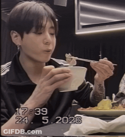 A Young Man Is Eating A Bowl Of Food With Chopsticks And The Date 17:29 GIF
