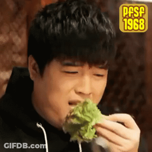 A Young Man Is Eating A Piece Of Lettuce With The Year 1968 On The Bottom Right GIF