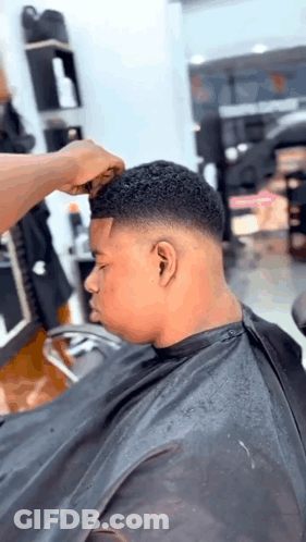 Young Man Getting Haircut At Barber Shop GIF