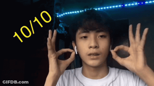 A Young Man Is Giving The Ok Sign With The Number 10 / 10 Behind Him GIF