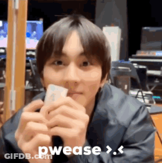 A Young Man Is Holding A Piece Of Paper In His Hands And Says Pwease > . GIF