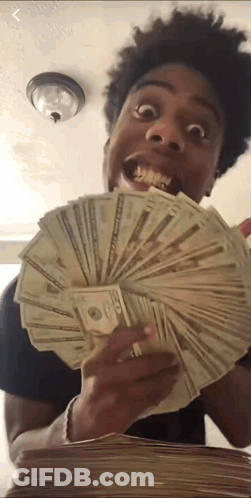 A Young Man Is Holding A Stack Of Money In His Hand . GIF