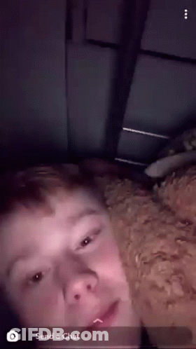 A Young Man Is Laying On A Bed With A Dog And A Snapchat Message That Says " Send A Chat " GIF