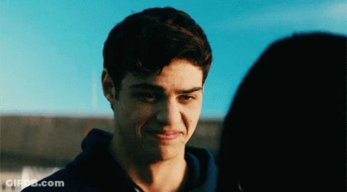 A Young Man Is Looking At A Woman With A Smile On His Face . GIF