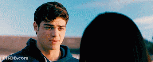 A Young Man Is Looking At A Young Woman . GIF