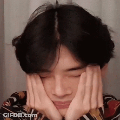 A Young Man Is Making A Face With His Hands . GIF