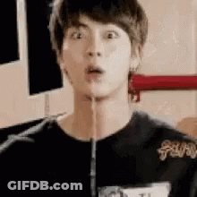 A Young Man Is Making A Funny Face While Holding A Hose In His Mouth . GIF