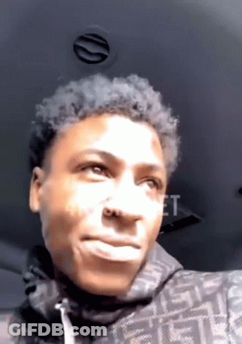 A Young Man Is Making A Funny Face While Sitting In The Back Of A Car . GIF