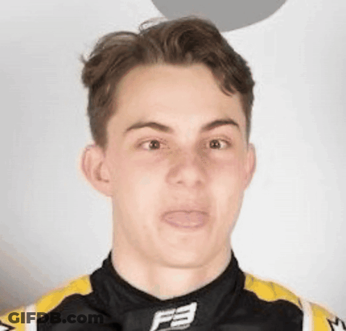 A Young Man Is Making A Funny Face While Wearing A Black And Yellow Shirt With The Letter F On It . GIF