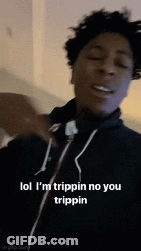 A Young Man Is Making A Funny Face While Wearing A Black Hoodie . GIF