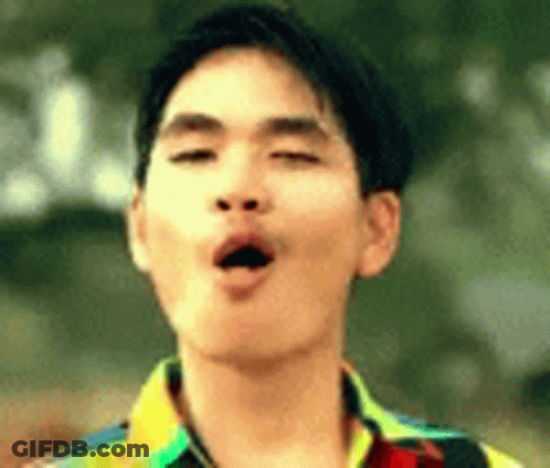 A Young Man Is Making A Funny Face With His Eyes Closed And His Mouth Open . GIF