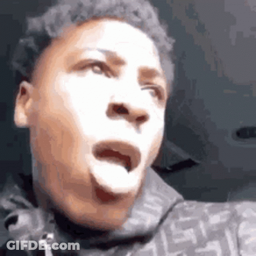 A Young Man Is Making A Funny Face With His Mouth Open And His Tongue Out . GIF