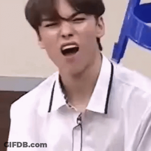 A Young Man Is Making A Funny Face With His Mouth Open . GIF