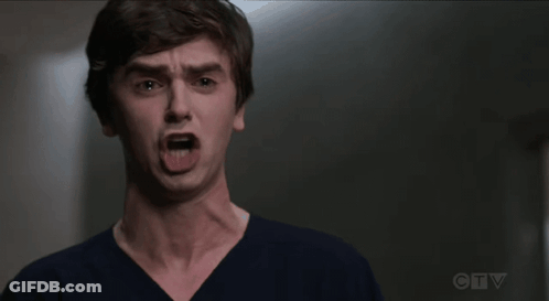 A Young Man Is Making A Funny Face With His Mouth Wide Open . GIF