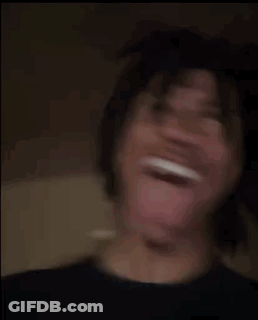 A Young Man Is Making A Funny Face With His Tongue Out . GIF