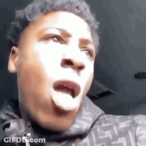 A Young Man Is Making A Funny Face With His Tongue Out . GIF