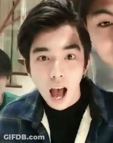 A Young Man Is Making A Funny Face With His Tongue Sticking Out . GIF