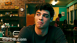 A Young Man Is Sitting At A Table In A Diner . GIF