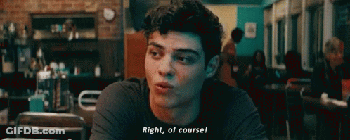 A Young Man Is Sitting At A Table In A Restaurant And Talking To Someone . GIF