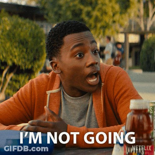 A Young Man Is Sitting At A Table With A Bottle Of Unfflix In Front Of Him GIF