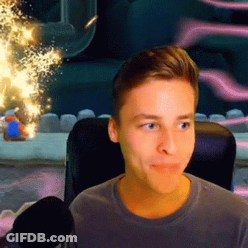 A Young Man Is Sitting In A Chair With A Microphone In Front Of Him Looking At The Camera . GIF