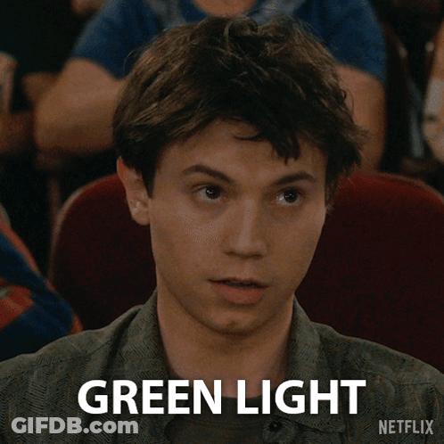 A Young Man Is Sitting In A Theater And Says Green Light Netflix GIF