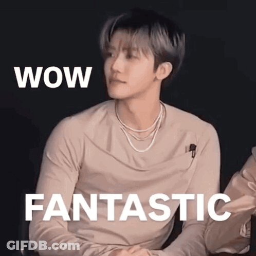 A Young Man Is Sitting In Front Of A Sign That Says Wow Fantastic . GIF