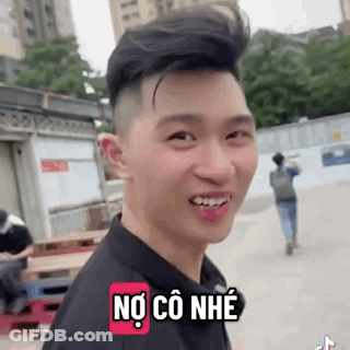A Young Man Is Smiling And Making A Funny Face While Wearing A Black Shirt And A Backpack . GIF