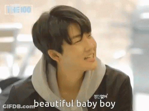 A Young Man Is Smiling And Says Beautiful Baby Boy In A Foreign Language GIF