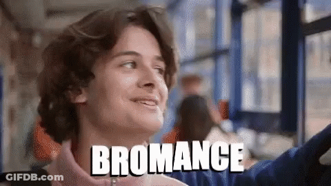 A Young Man Is Smiling And The Word Bromance Is On The Bottom GIF