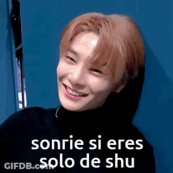 A Young Man Is Smiling And Wearing A Black Turtleneck . GIF